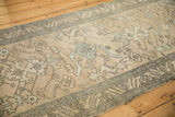 Angled view of a vintage Heriz runner's geometric motifs and softly distressed, low-pile texture.