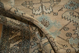A soft fold in the vintage Heriz runner highlights the textured pile and blue serrated leaf design.