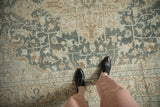 Low-pile texture and even wear on a vintage Tabriz rug with scrolled blossoms in dusty teal and cream.