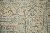 Evenly worn pile on the corner of a vintage Tabriz showing the geometric Herati border.