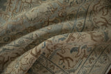 Hand-knotted texture of a distressed Tabriz carpet with even wear in dusty teal and sand tones.