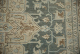 Even wear on a distressed Tabriz carpet's pile, showing pale teal and brown geometric vines.