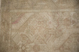 Distressed vintage Tajabad rug pile, showing mostly even wear and faint magenta motifs.