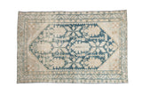 Vintage distressed Hamadan rug with a large dusty blue medallion and floral palmettes over a worn ivory and sand field.