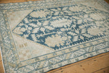 Decorative wear on a vintage Hamadan rug with dusty cobalt blue palmettes.