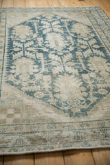 Angled perspective revealing the worn, hand-knotted texture of the vintage rug.