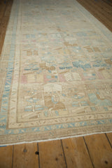 Angled perspective view of a distressed Persian runner showing its soft, time-softened pile.