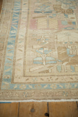 Close-up of the vintage Persian runner's distressed texture and powder blue border design.