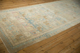 Angled view of a vintage Persian runner's soft patina and muted pastel hues.