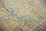 Evenly worn pile showing knot heads and geometric motifs in dusty blue, mauve, and antique ivory.