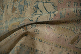 Soft, pliable texture of a distressed Persian rug showing its evenly worn, hand-knotted pile.