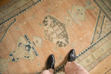 A top-down view highlighting the soft, distressed texture of a vintage Hamadan rug.