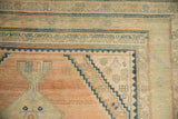 Stepped corner spandrel with nuanced relief in tones of sandalwood, navy, and jade green.