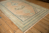 Angled view of a vintage Hamadan rug showing its stepped corner spandrels and time-softened pile.