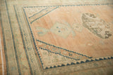 Stepped contour corner spandrel in dusty navy blue on a vintage distressed Hamadan rug.