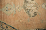Evenly worn low pile of a distressed Hamadan rug with sandalwood, jade, and navy motifs.