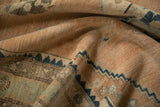 Soft folds showing the nuanced relief and low-pile texture of a distressed vintage Hamadan rug.