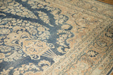Distressed vintage Meshed rug with cream floral bouquet motifs on a navy field.