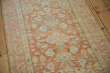 Low, even pile texture of the vintage Lilihan runner in soft terracotta and blush tones.