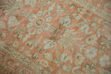 Detailed view of even wear on the vintage Lilihan rug with terracotta and muted silver floral motifs.
