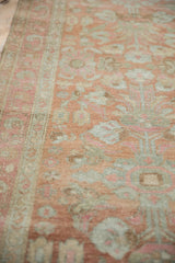 Soft, low pile texture of a distressed Persian runner in faded terracotta and silver.