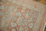 Hand-knotted floral motifs and boteh border with time-softened terracotta and silver hues.