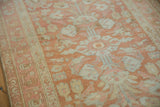 Detailed weave of a vintage Lilihan runner showing floral motifs in terracotta, blush, and platinum.