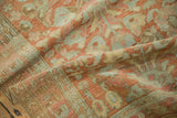 Distressed Persian rug runner showing a soft, pliable texture in terracotta, silver, and blush tones.