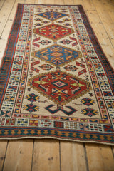 A vintage Serab runner seen from an angle, showing the series of geometric medallions.