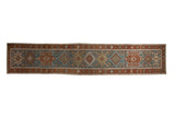 Vintage distressed Karaja runner with a single column of alternating medallions in dusty teal and chestnut.