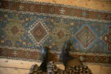 Geometric medallions and Samovar borders in chestnut and jade on the distressed dusty teal Karaja runner.