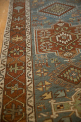 Close-up of the Samovar and meandering vine borders on a distressed Karaja rug in dusty teal and chestnut.
