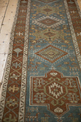 Angled perspective of a vintage Karaja runner's geometric medallions and starburst Samovar borders.
