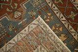 Tidy hand-knotted back and secure machine-bound edge of a distressed vintage Karaja runner.