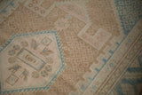 Tone-on-tone diamond-shaped seeds on the coffee-brown field meet dusty rose and blue geometric motifs.