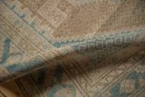 Folded vintage Hamadan rug highlighting its textured low pile in dusty blue and coffee brown.