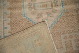 The dense hand-knotted foundation and distressed, low-pile surface of a vintage Persian rug.