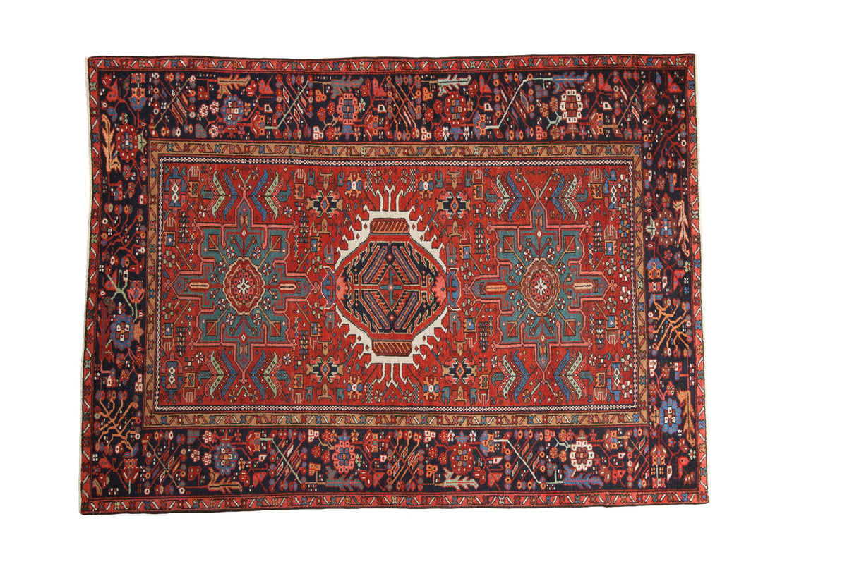 Vintage Karaja rug featuring a classic triple center medallion on a madder red field with a dark navy border.