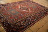 Angled view of a vintage Karaja rug showcasing its traditional geometric pattern and rich colors.