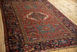 Angled perspective on a vintage Karaja rug, showing the texture of its triple medallion design.