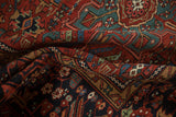 Dense wool pile and geometric blossoms of a vintage Karaja rug in madder red and mallard green.