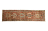Distressed vintage Karaja runner with geometric medallions in rust, dusty seafoam green, and ivory.