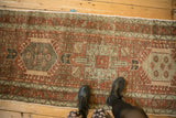 Showing the decorative, time-softened wear on a geometric Persian Karaja rug runner.