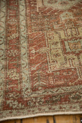 Low pile showing knot heads on the distressed Persian Karaja rug's geometric border.