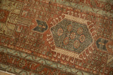 Detail of a geometric medallion with hook and latch design on a distressed vintage Karaja runner.