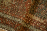 Low pile and visible knot heads on a folded Karaja runner in rust and seafoam.