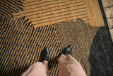 Detailed view of the hand-knotted pile and abstract checkered design on a Moroccan style carpet.