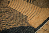 Detail of the varied pile height in the carpet's abstract checkered and linear design.