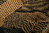 High and low pile detail of a hand-knotted rug with abstract checkered and linear patterns.