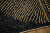 Intact side cord selvage framing the abstract checkered, hand-knotted pile of the carpet.